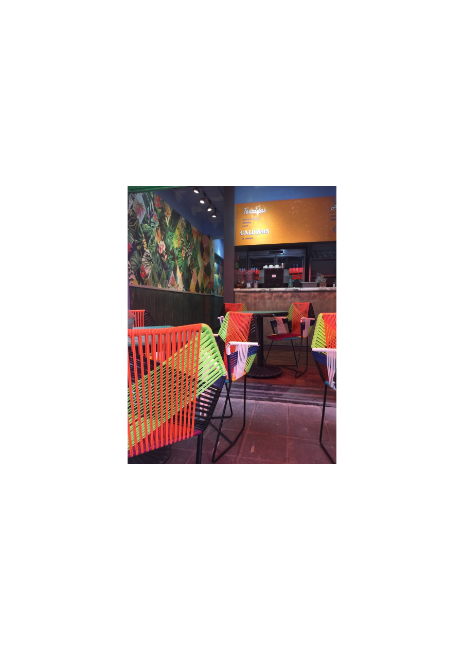 A vibrant restaurant with colorful chairs and tables, creating a lively and inviting atmosphere.